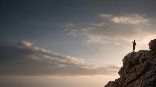 lone figure stands on rocky cliff at sunset raising hand in warning gesture