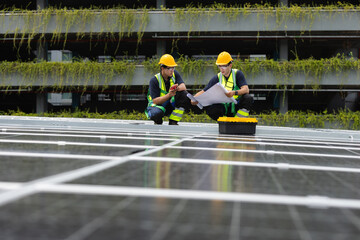 Team technicians and engineers working installing and inspection standards of solar panels on roof of industrial factory. Energy solutions from nature sunlight clean renewable.