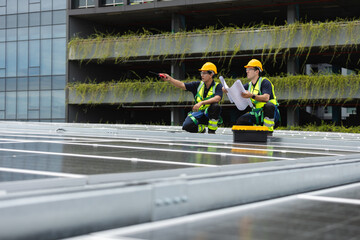 Team technicians and engineers working installing and inspection standards of solar panels on roof...