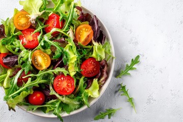 Fresh salad with lettuce, arugula and cherry tomatoes in a bowl, representing a healthy spring or summer meal