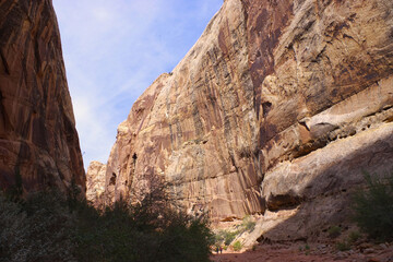 Narrow sandstone canyon with hikers at Capitol Reef National Park Utah