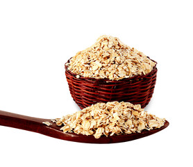 rolled oats flakes isolated for breakfast in basket and wooden spoon, cutout in transparent...