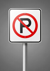 A no parking sign is posted on a metal pole
