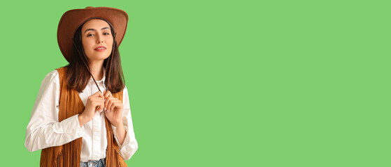 Beautiful cowgirl on green background