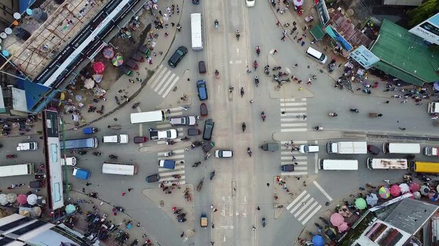 Aerial view of a busy intersection with cars buses motorcycles and pedestrians crossing the street zone tanzania