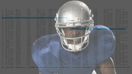 Football player crouching and receiving sports data on gray backdrop raising head adjusting helmet - Powered by Adobe