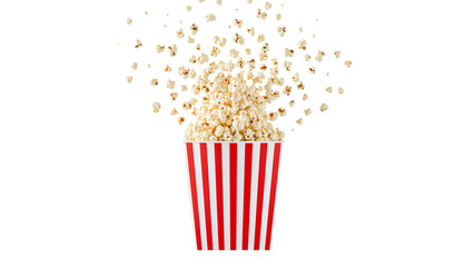 Festive Popcorn Cascade in Striped Container on Isolated Transparent Setting
