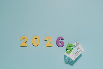 Numerals 2026 stand boldly as 5 rests in a white basket. Perfect for themes of transition, progress, and anticipating the year 2026.