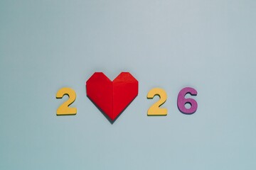 2026 with a vibrant red origami heart on blue. Perfect for themes of love, hope, and the future year.