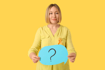 Happy mature woman with ribbon and speech bubble on yellow background. Multiple Sclerosis Awareness Month