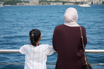 Mother and daughter enjoying a day by the waterfront