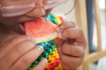 Child enjoying a slice of watermelon on a sunny day