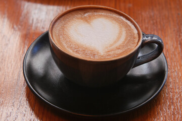 Heart-shaped latte on a wooden table
