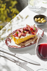 Baked polenta with roast beef, bright sunlight, overhead composition, Hungarian summer menu focus