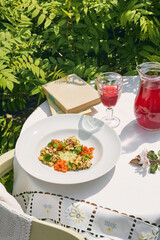 Salmon tartare with potato salad, bright outdoor lighting, overhead composition