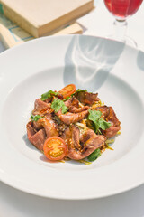 Roast beef salad with cherry tomatoes, bright daylight, overhead minimal composition