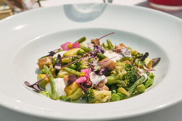 Green salad with salmon and creamy sauce, bright lighting, minimalist closeup composition