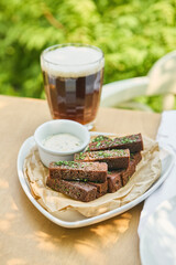 Borodinsky rye bread croutons with garlic on rustic bright tabletop, overhead outdoor composition