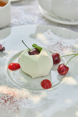Cherry mousse pastry with creamy glaze, bright daylight, minimal overhead composition