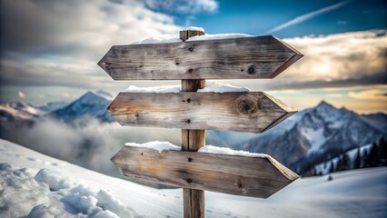 Wooden directional signpost covered in snow with majestic mountain landscape background
