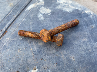 old rusty metal screw on the floor