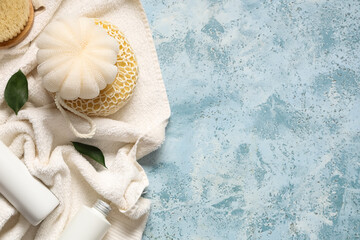 Composition with bath supplies and cosmetic products on color grunge background