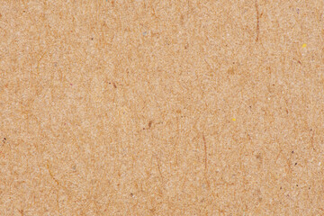 Close-up of textured brown cardboard with fibers and subtle imperfections