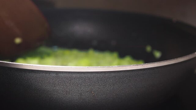 Cooking onions and garlic in a frying pan