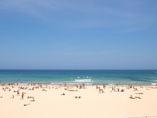 December 16, 2009. Sydney, Australia. Bondi Beach on a sunny day, bustling with sunbathers and swimmers enjoying the iconic sandy shores and clear blue waters.