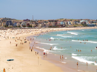 December 16, 2009. Sydney, Australia. Bondi Beach on a sunny day, bustling with sunbathers and swimmers enjoying the iconic sandy shores and clear blue waters.