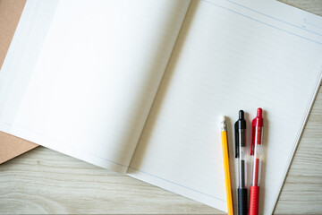 Open notebook with pens