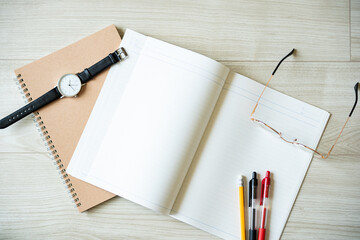 Open notebook with pens