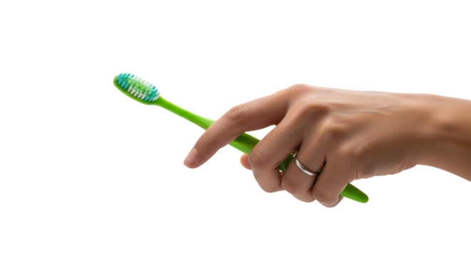 Hand holding a green toothbrush with blue and white bristles wearing a silver ring.