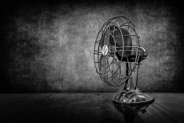 Horizontal Image of an Antique Four Blade Fan presented in black and white