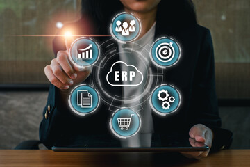 Businesswoman using ERP software on a tablet, showcasing digital transformation in enterprise management.