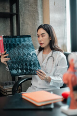 Female doctor in white coat examining an X-ray in a modern medical office setting.
