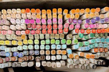 Colorful alcohol markers neatly arranged in rows, top view, vibrant art supplies collection