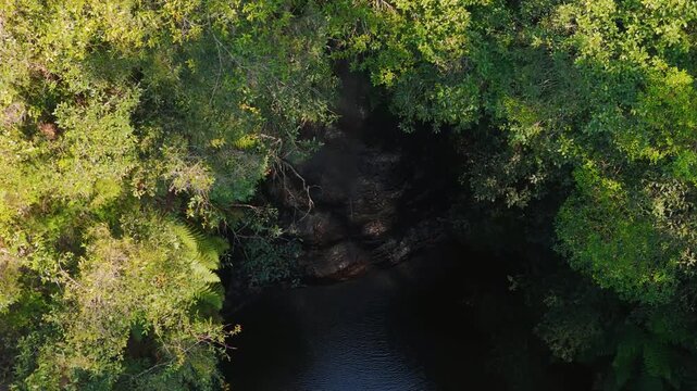 Blue Mountains, NSW, Australia: UHD Drone Video &ndash;Flying down from above the canopy to the waterfall and the water pool below at South Lawson's 5 Waterfalls Circuit walking track.