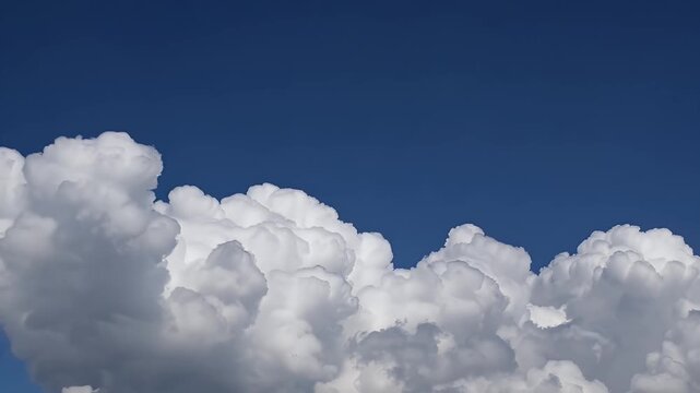 magnificent cumulonimbus clouds surge skyward in time lapse motion revealing immense vertical towers of white and gray that gradually part to unveil brilliant blue skies evoking the drama of