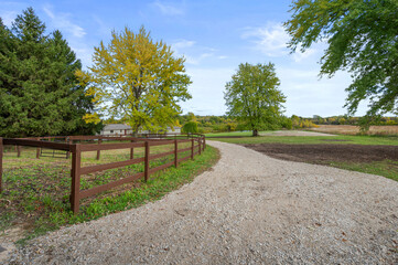 Gravel Farm Driveway with Wooden Horse Fence Alongside