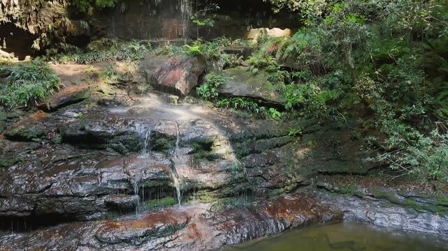 Blue Mountains, NSW, Australia: UHD Drone Video -Flying up close to Junction Falls in Australian rainforest on the South Lawson's 5 Waterfalls Circuit walking track.