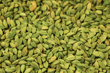 Pile of fresh green Cardamom Pods closeup for food background use.