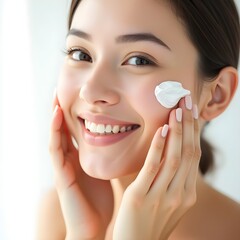 Beautiful woman applying face cream skincare routine smiling indoors