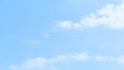 Obraz premium The blue morning sky is decorated with soft and calming white clouds. Blue sky with clouds. Soft white clouds float in the clear blue sky. Clear blue sky, bright spring, wallpaper landscape.