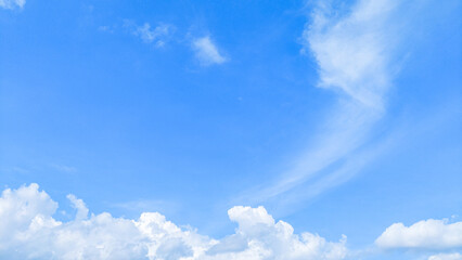 The blue morning sky is decorated with soft and calming white clouds. Blue sky with clouds. Soft white clouds float in the clear blue sky. Clear blue sky, bright spring, wallpaper landscape.