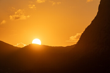 Sunset Mountains Light: Dusk in Saint Lucia, with sun setting behind Pitons for scenic views.