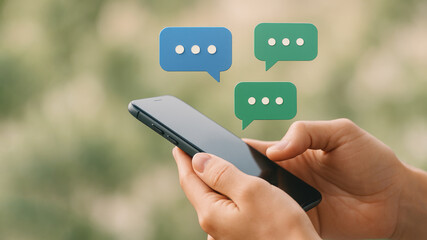 Hands holding phone with blue and green chat bubbles mobile device