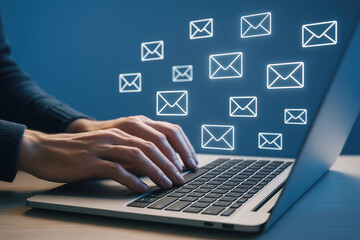 Hands typing on laptop with glowing email icons computer keyboard