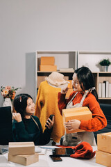Portrait of Starting small businesses SME owners, two Asian woman check online orders Selling...