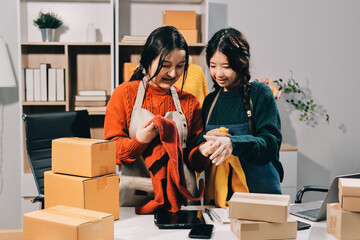 Portrait of Starting small businesses SME owners, two Asian woman check online orders Selling...